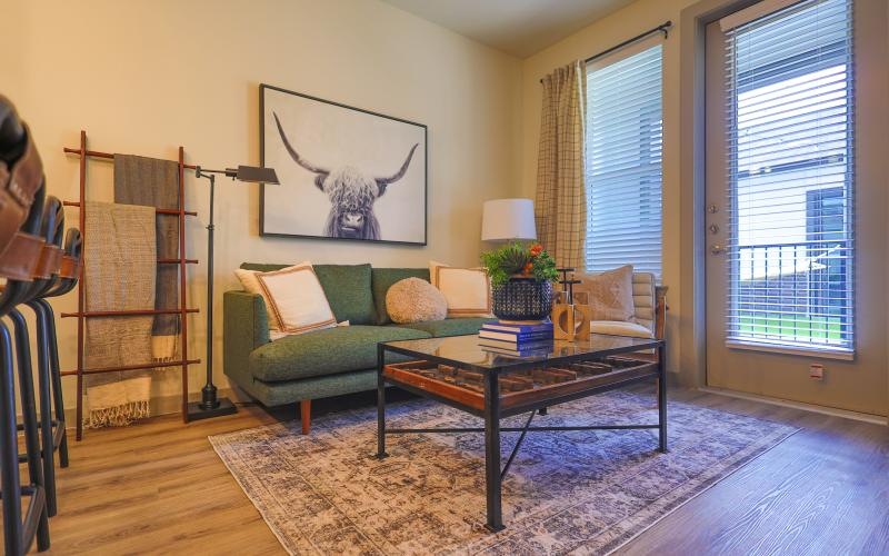 a living room with a green couch and a coffee table