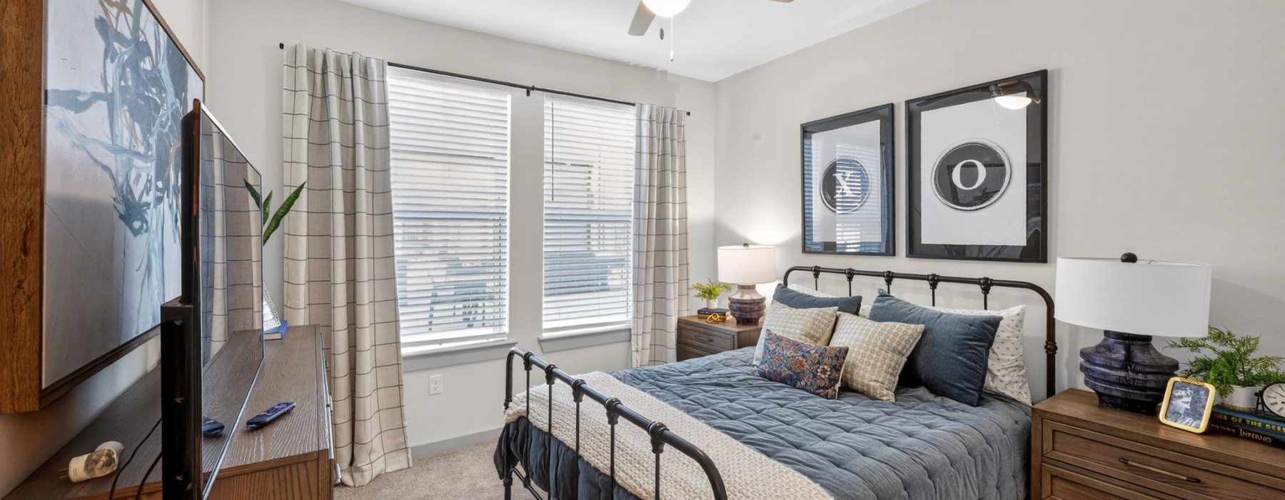 Primary bedroom with carpet throughout and natural lighting