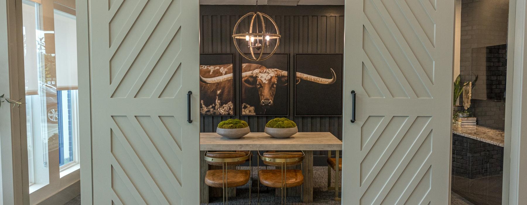 a dining room with a table and chairs