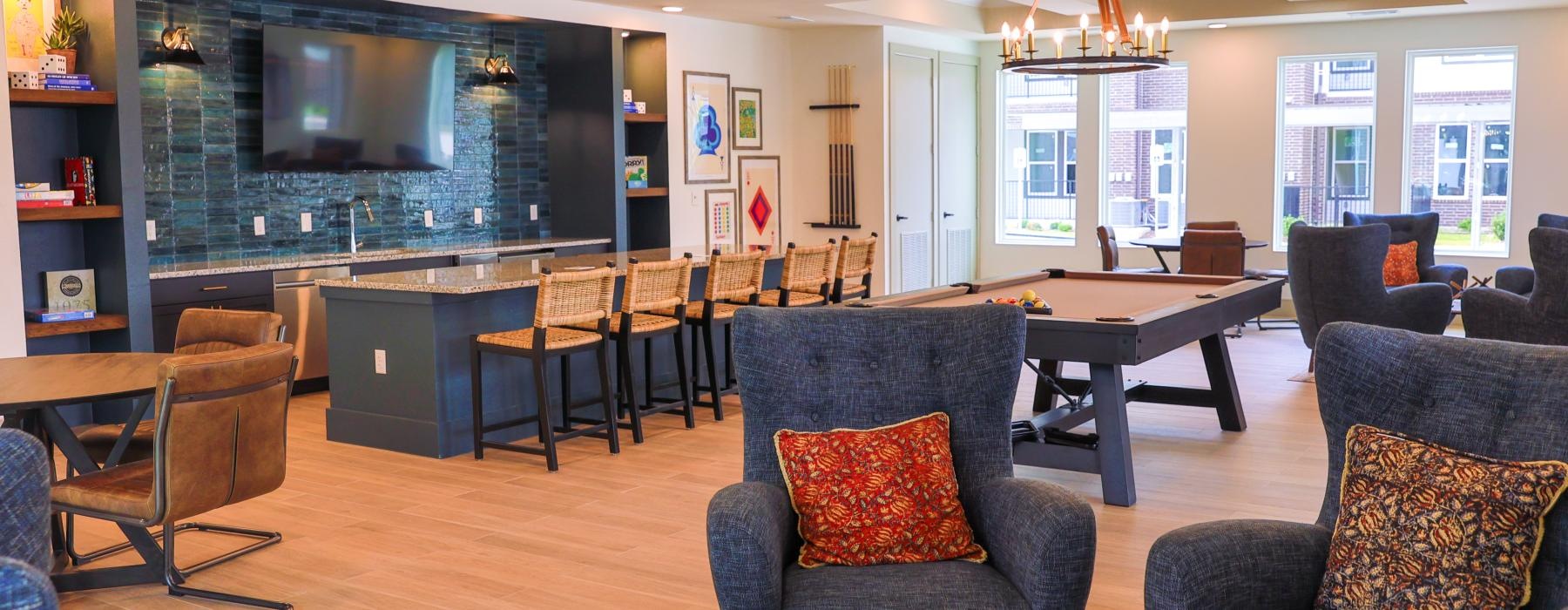 a large living room with a large tv and chairs