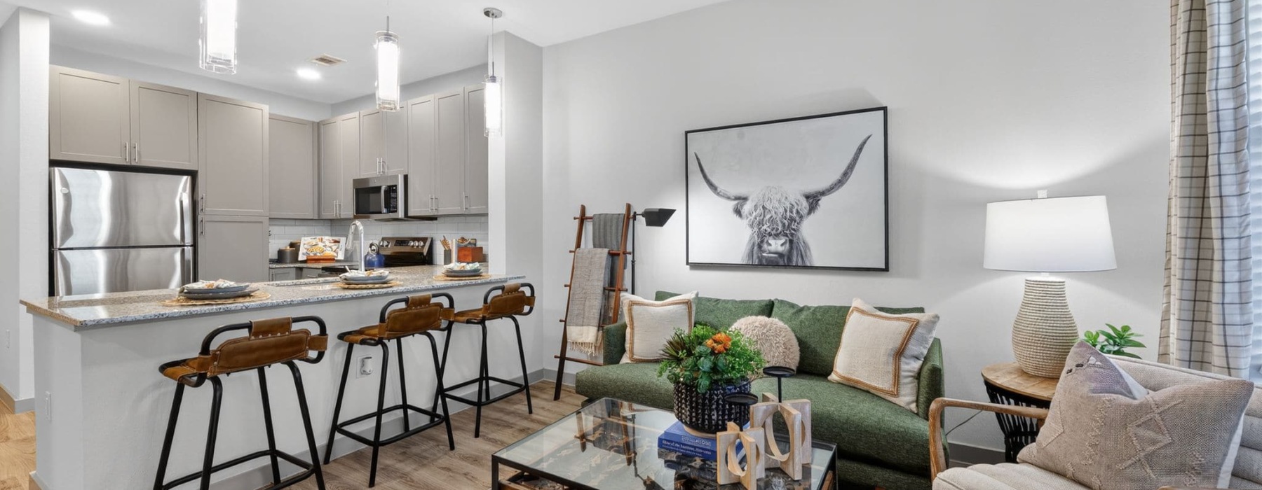 living room with chairs and view of a kitchen