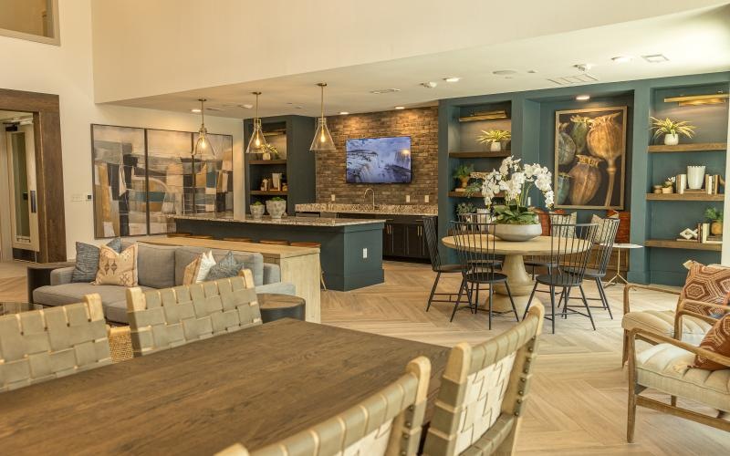 a room with a table chairs and a tv